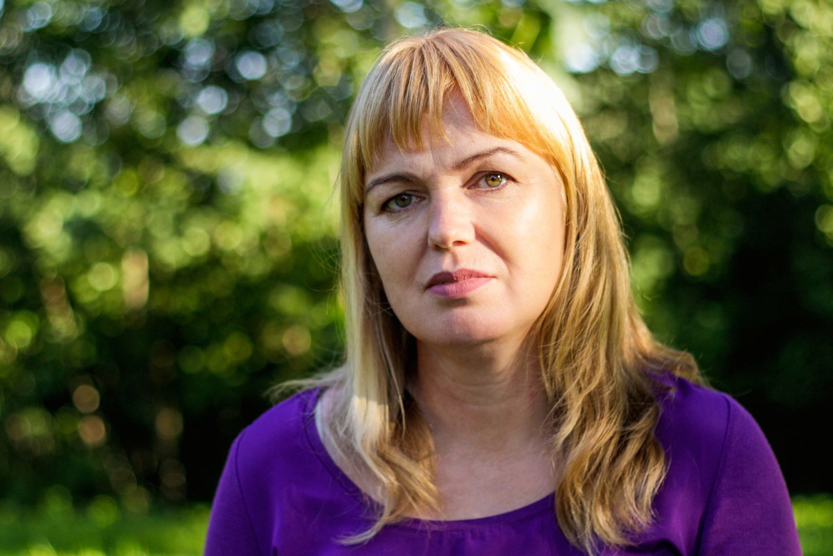 Serious Blonde Woman In Her 40S In Park. Mature Woman With Blonde Hair In Summer Park.