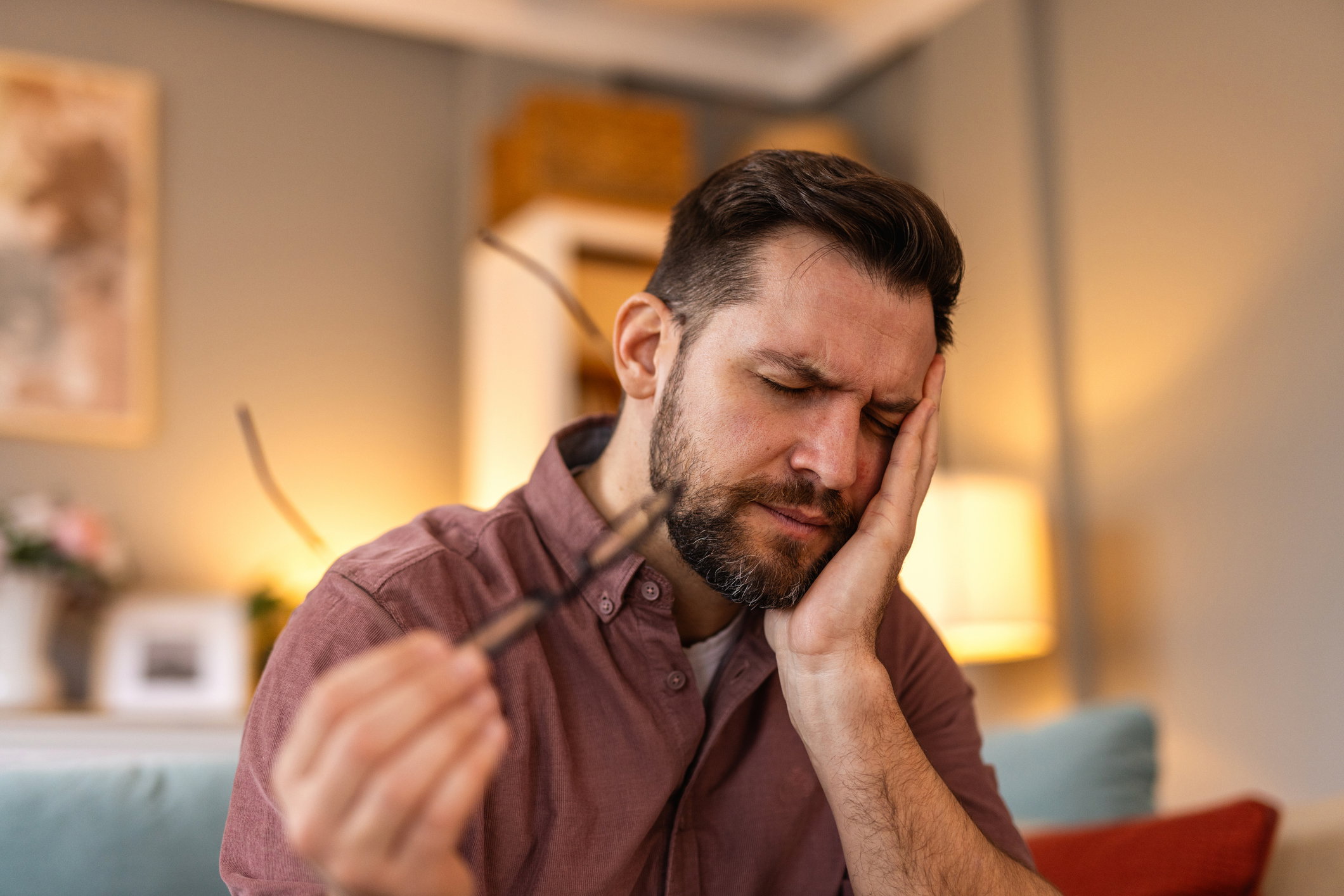 Tooth Pain And Dentistry. Young Man Suffering From Terrible Strong Teeth Pain, Touching Cheek With Hand. Feeling Painful Toothache. Dental Care And Health Concept. High Resolution