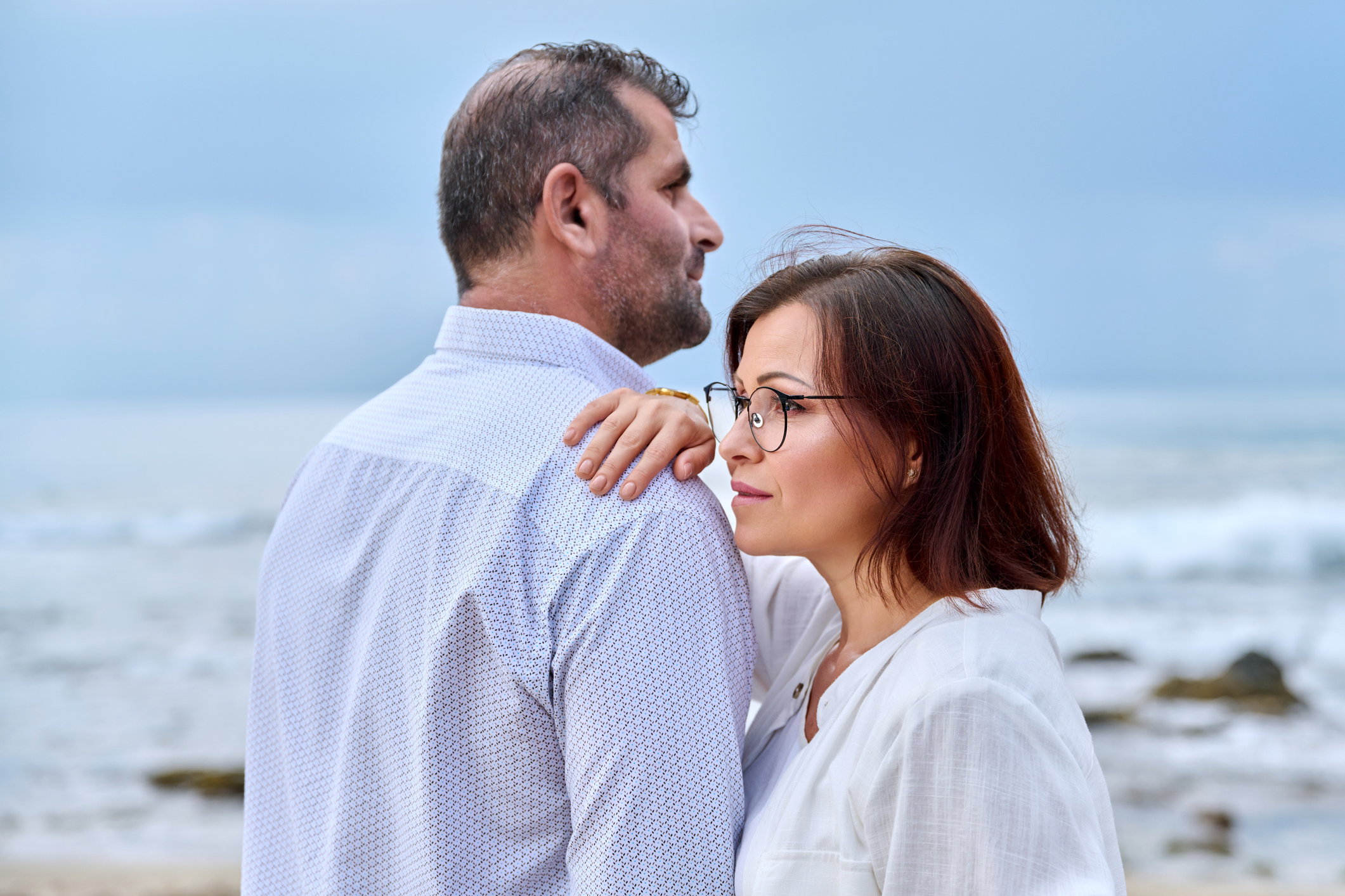 Outdoor portrait of mature couple hugging on the seashore
