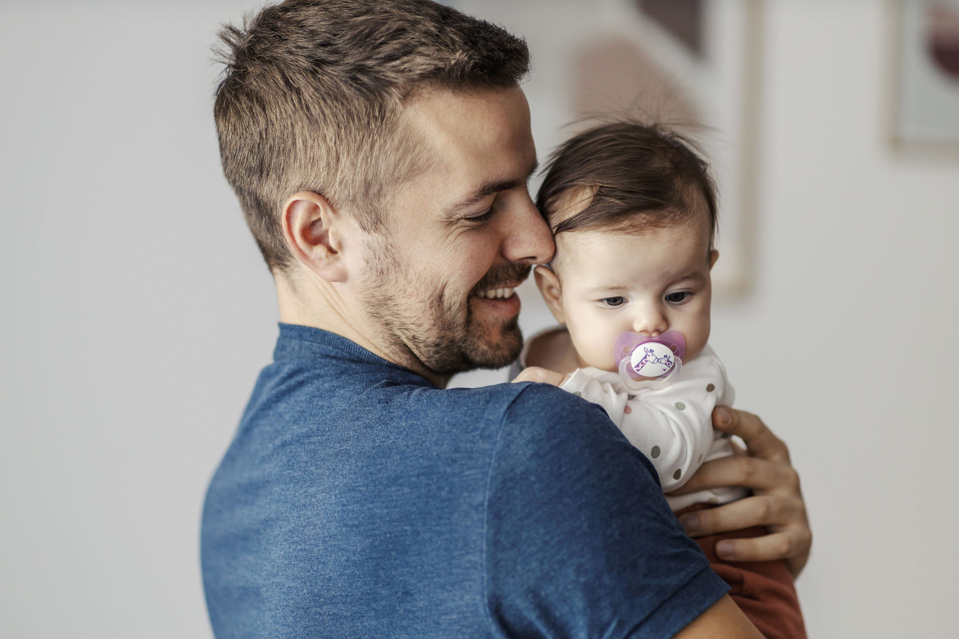 A happy father hugging his little daughter.