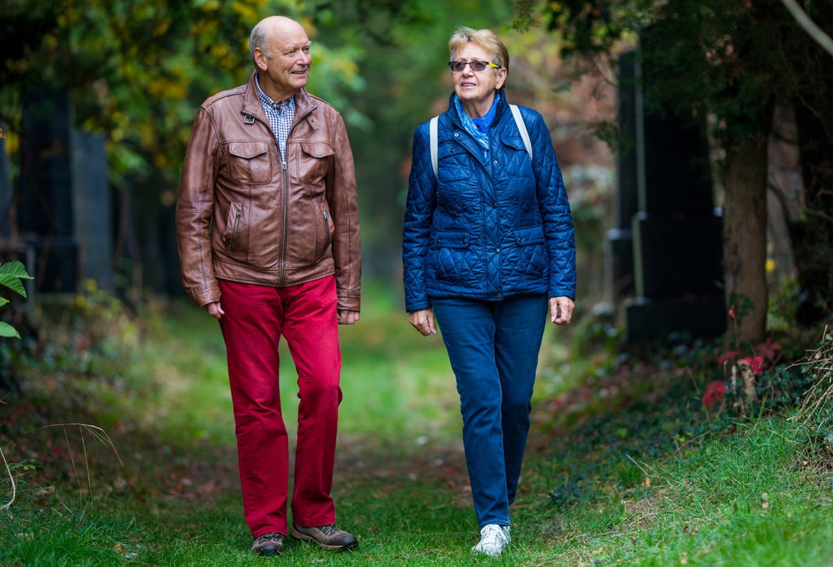 para seniorów 70 plus spaceruje po cmentarzu wczesną jesienną porą