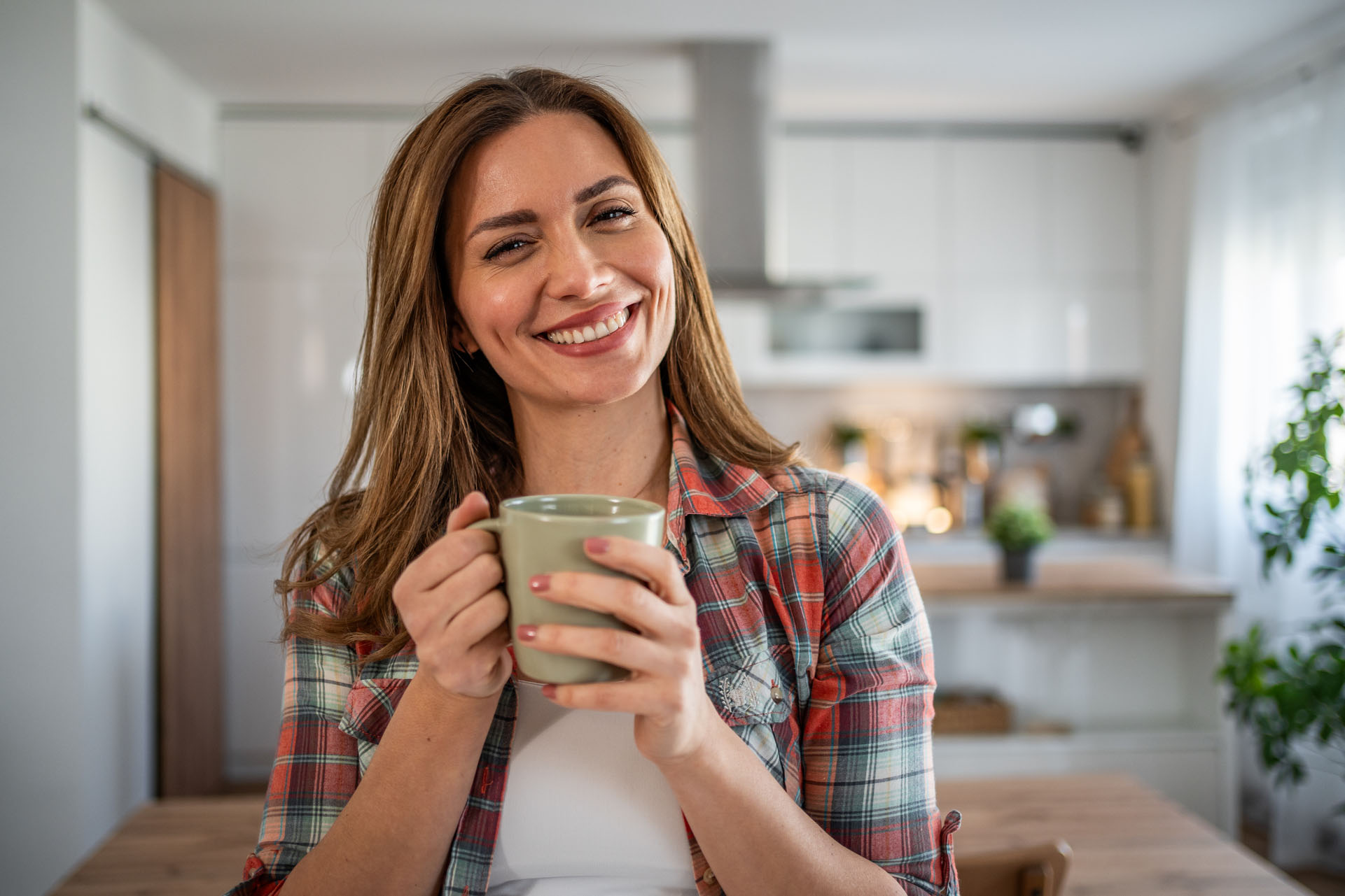 Soothing rhythm of the morning - A young woman enjoys her morning coffee in her kitchen