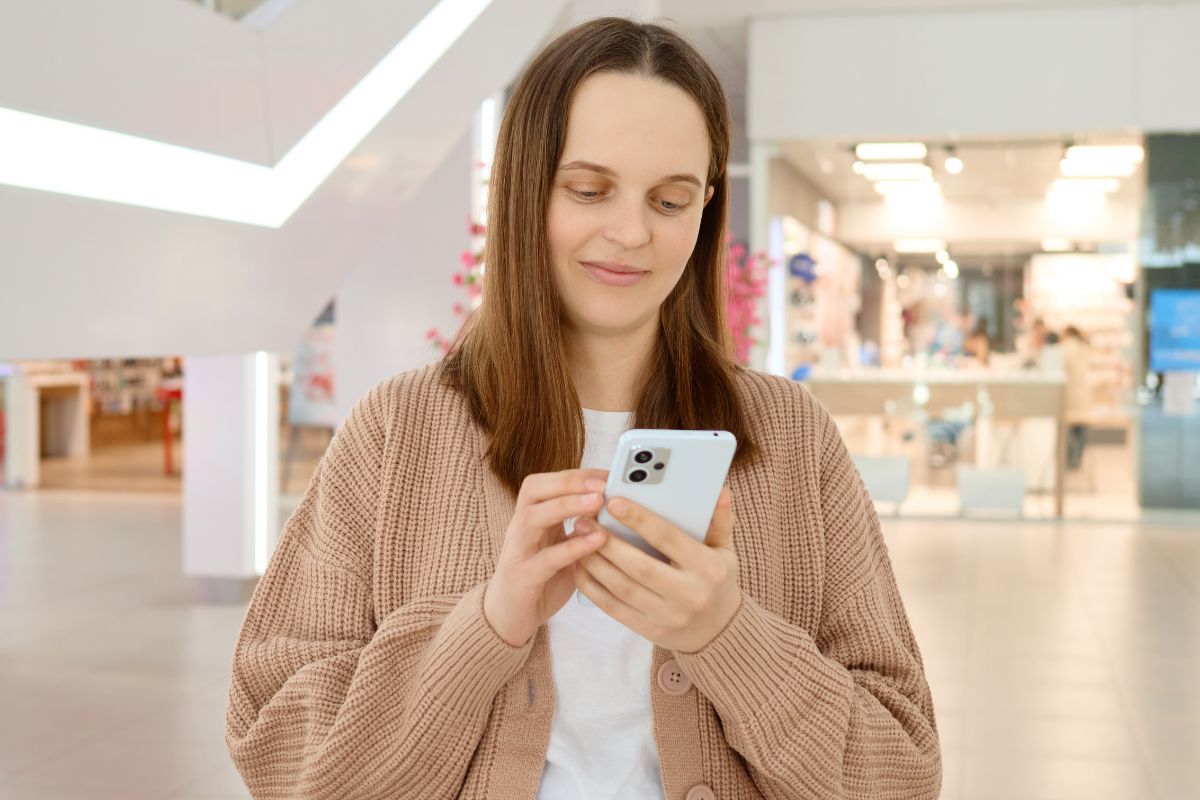 Kobieta z telefonem w galerii handlowej