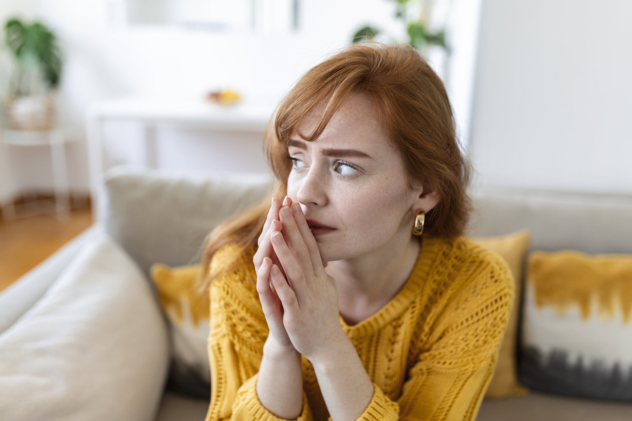 Sad woman feels miserable desperate sit on sofa look out the window thinking about personal troubles does not see way out of difficult life situation. Break up, heartbreak, cheated girl concept
