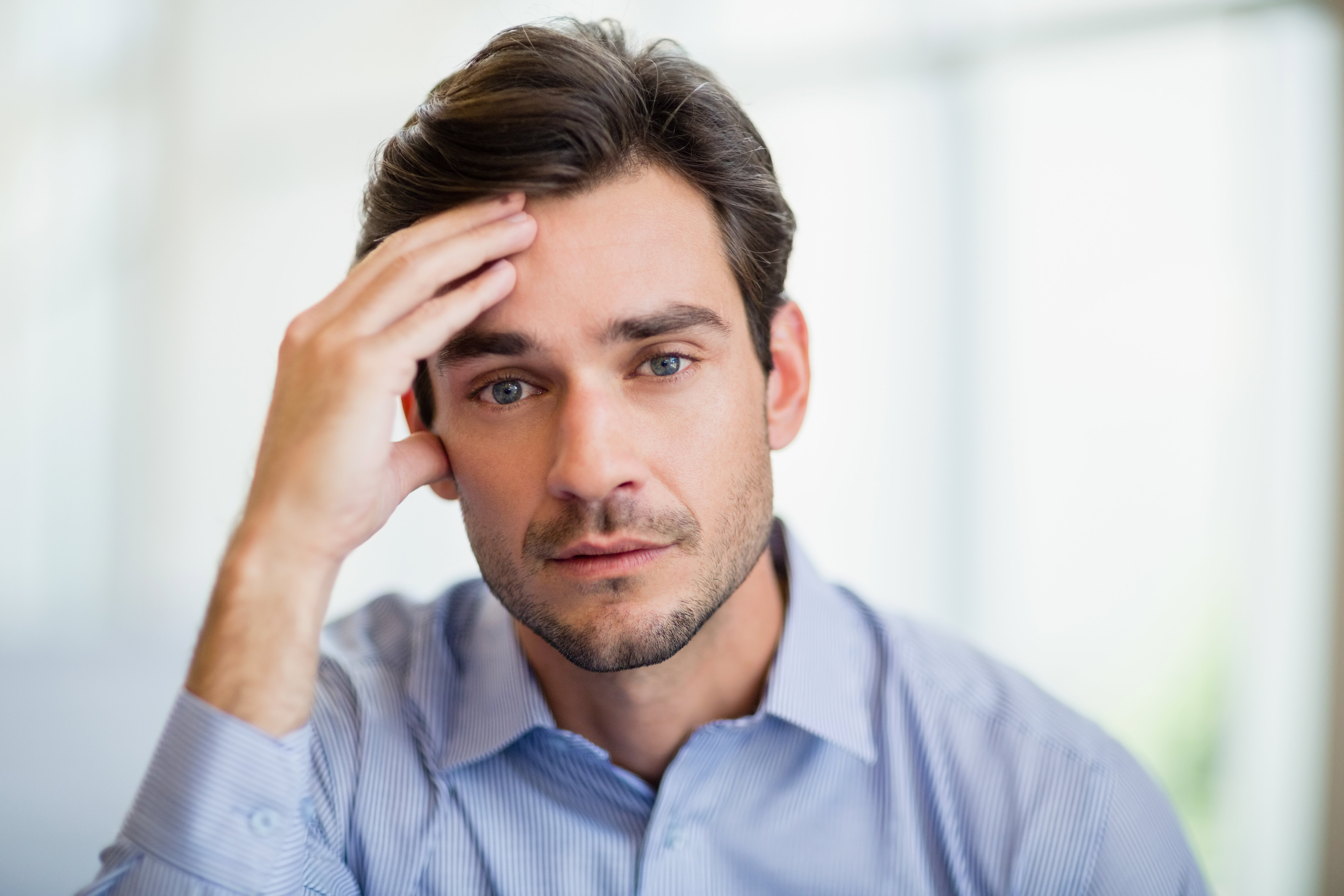 Worried businessman with hand on head