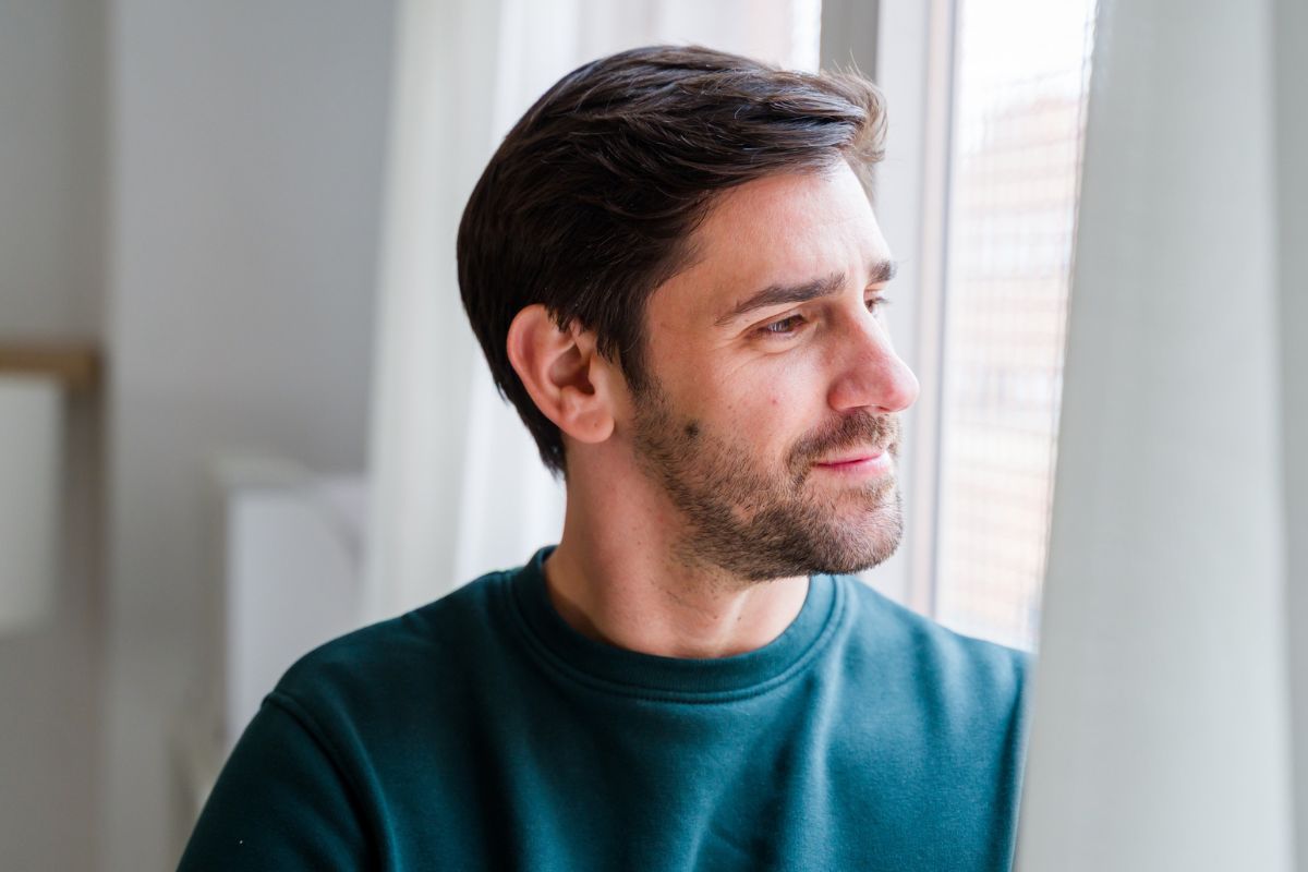 mężczyzna patrzący przez okno