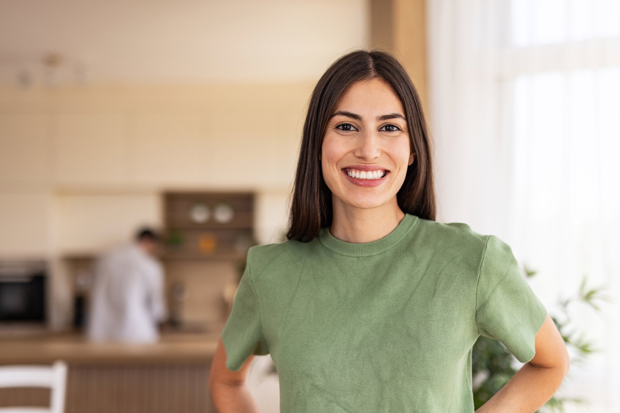 Portrait of smiling young woman posing at home in kitchen