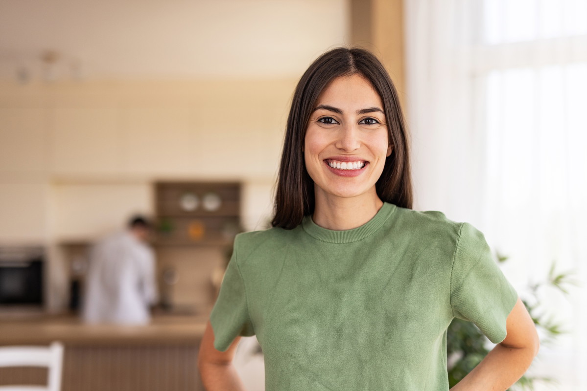 Portrait of smiling young woman posing at home in kitchen