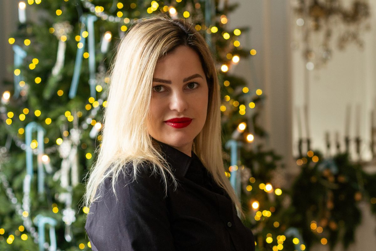 kobieta na tle choinki z bombkami