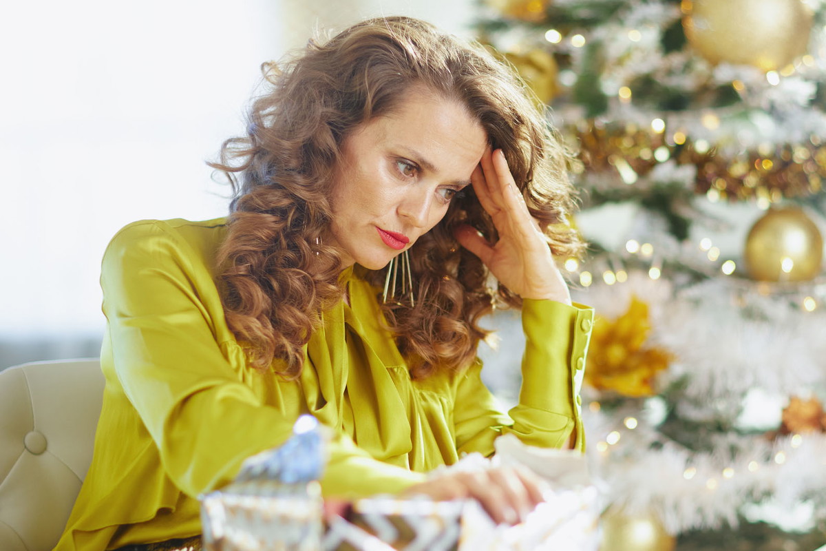 Reflective Woman with Open Christmas Gift
