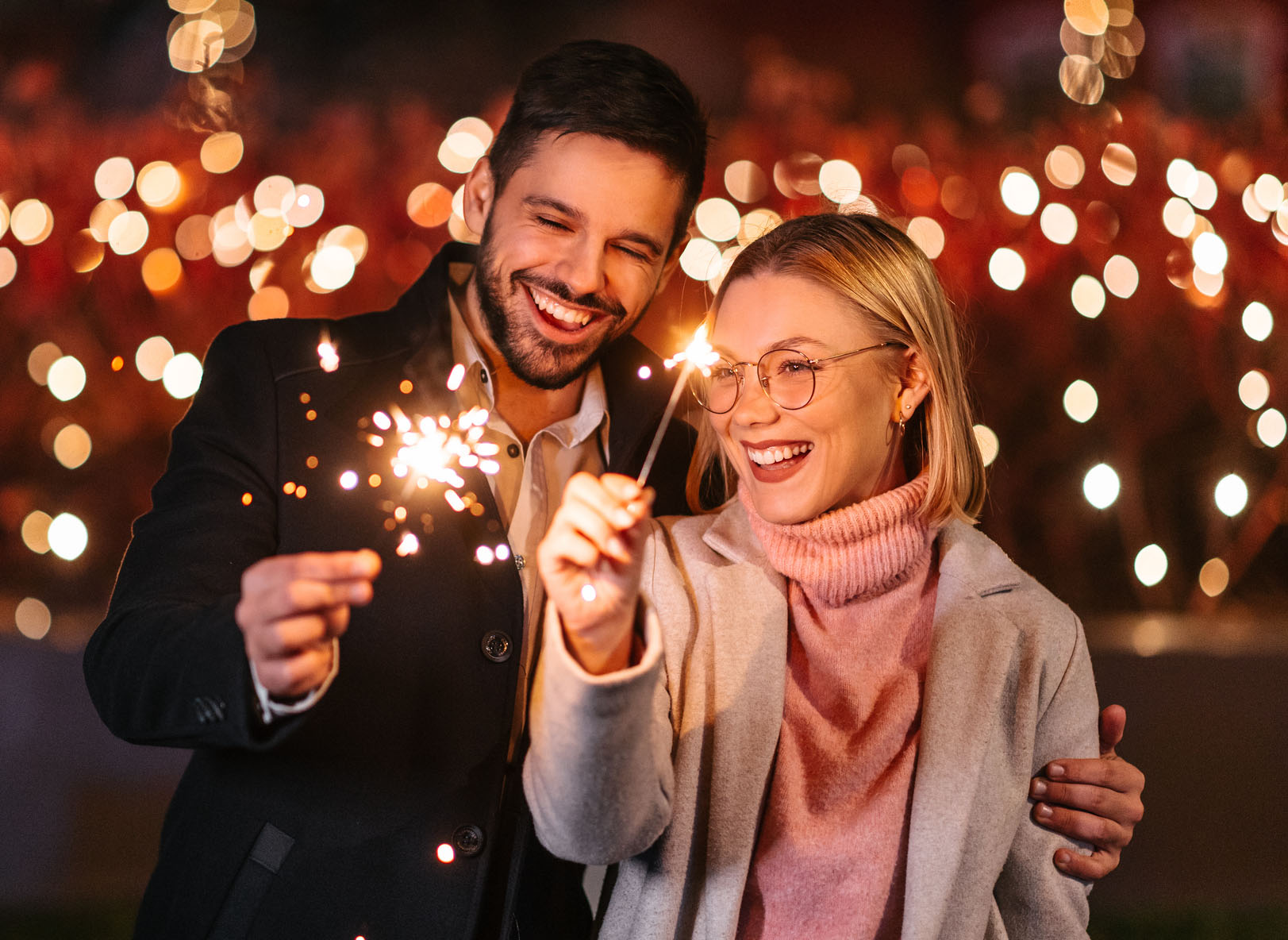 Couple holding sparklers