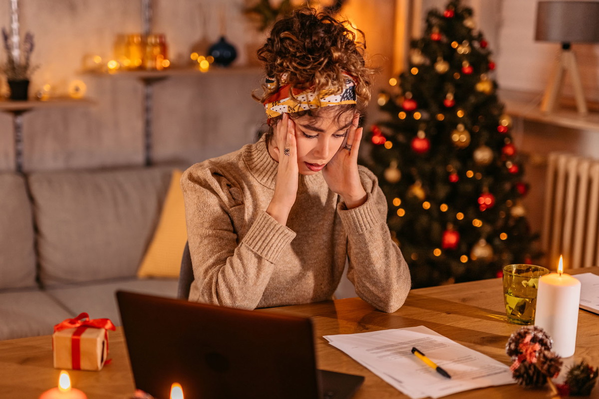 Worried Young Woman Managing Finances At Home During Christmas Holidays