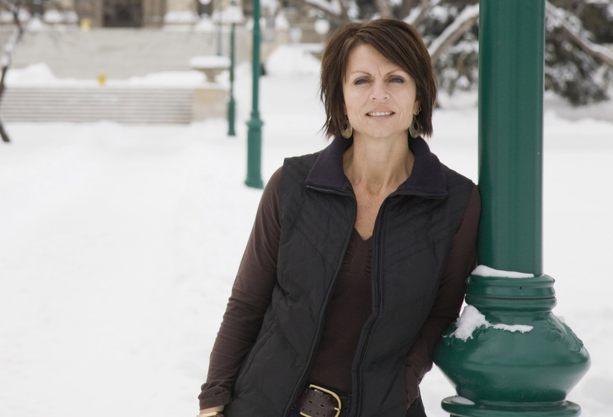 kobieta w wieku 35 plus stoi na zaśnieżonej ulicy z poważnym wyrazem twarzy