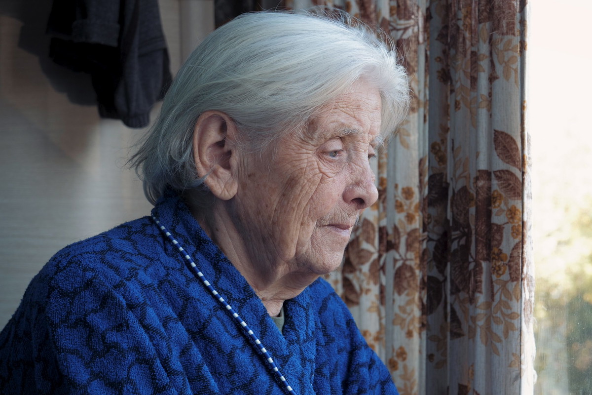 Sad Old Gray Haired Woman Looks Out Of Window Misses Her Family