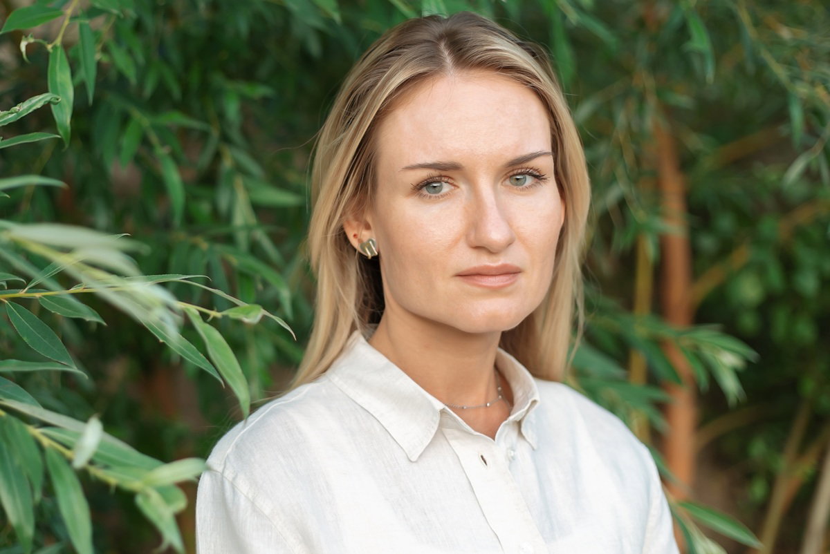 kobieta w wieku 30 plus blondynka stoi na tle wierzb smutna i zamyślona