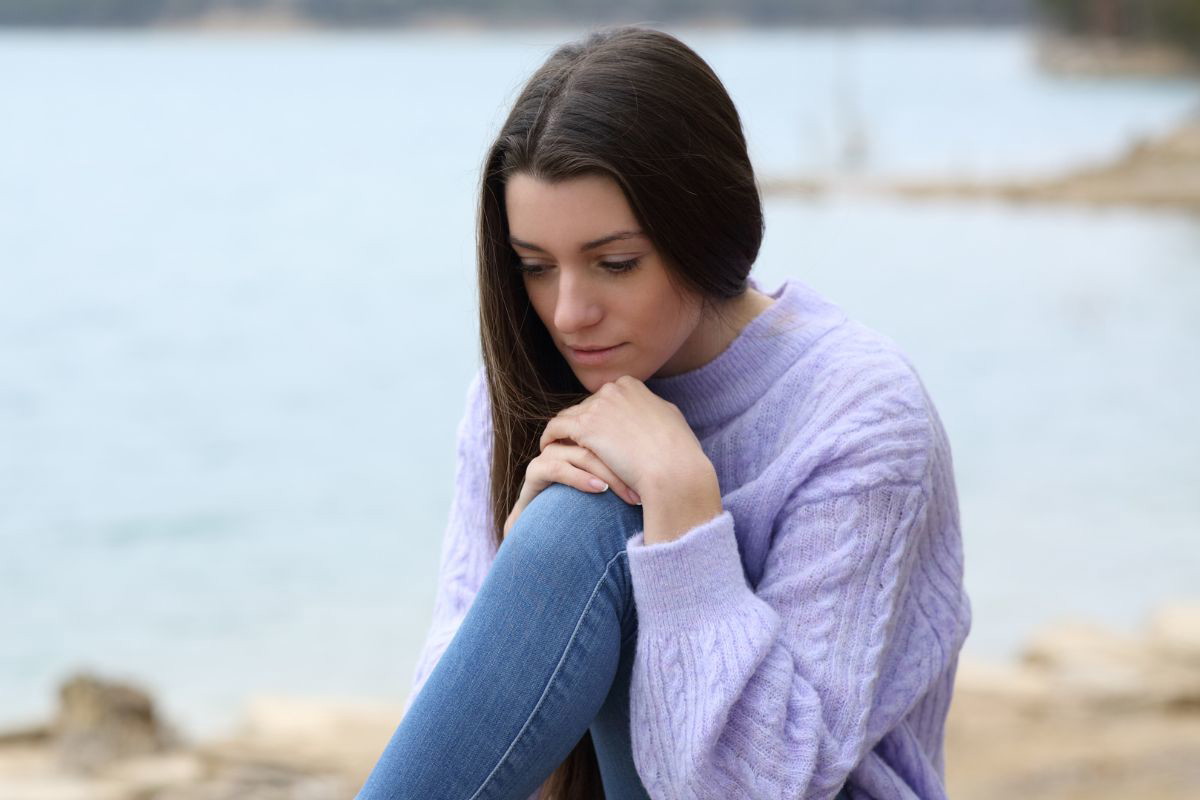 Smutna kobieta nad jeziorem