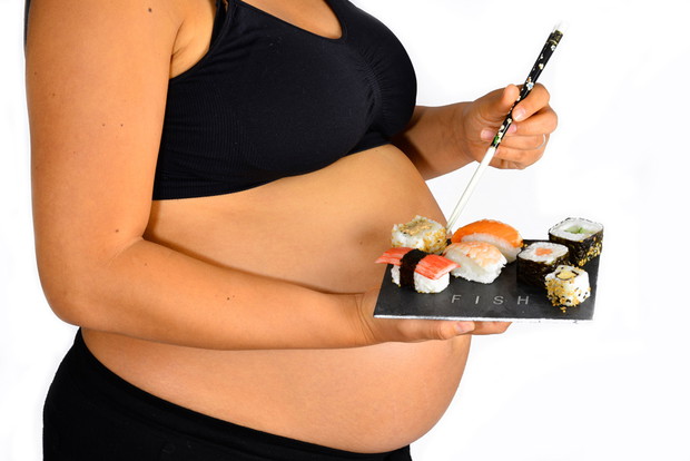 Pregnant woman with sushi