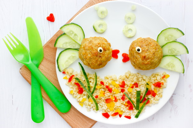 Fish meatballs with porridge and vegetable slices for funny and