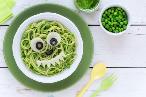 Fun food for kids - cute smiling face of green spaghetti monster