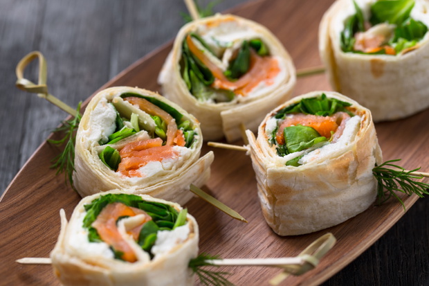 tortilla rolls with salmon, cream cheese and salad, catering sna