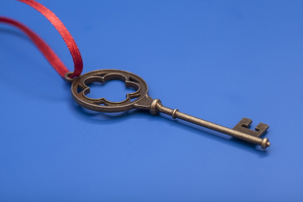 Key To Success With Red Bow isolated on blue background