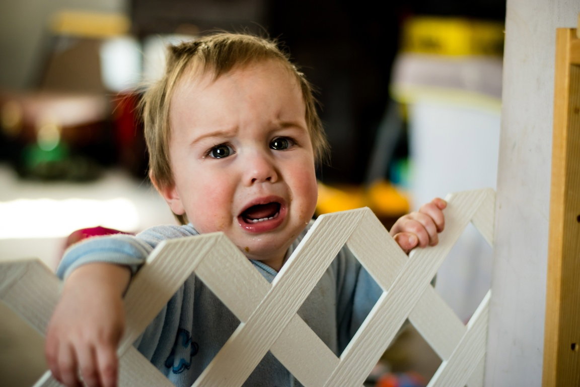 Płaczące dziecko za barierką