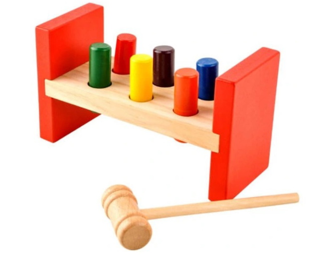 Baby boy playing with wooden toys lying on the Mat. Ecology, education, upbringing concept