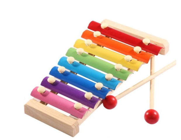 Baby boy playing with wooden toys lying on the Mat. Ecology, education, upbringing concept