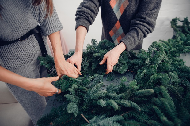 Christmas tree wreath decoration with woman hand workshop DIY