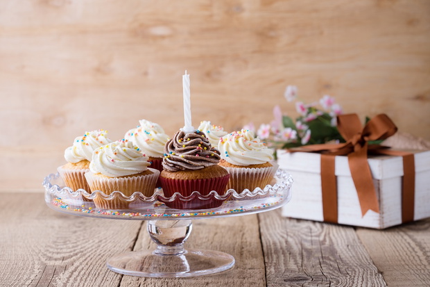 Delicious birthday cupcakes with one candle