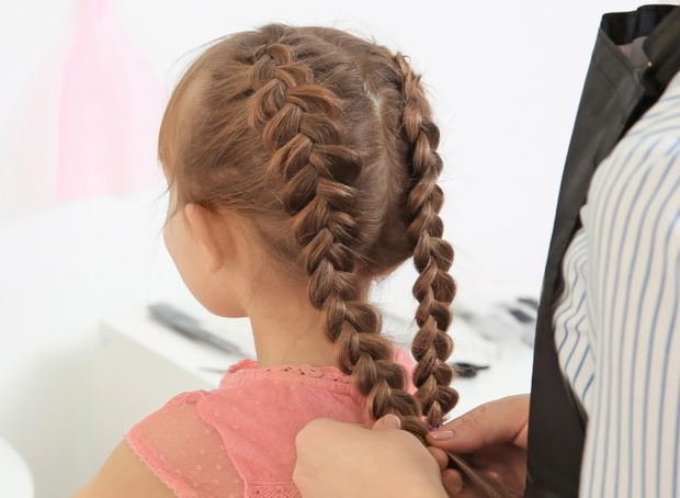 Cute little girl in hairdressing salon
