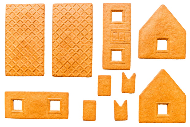 baked parts for build of Christmas gingerbread house on a white