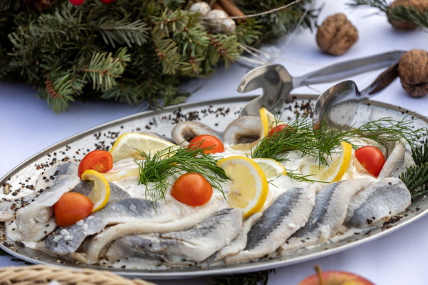 Marinated herring fillets in a cream sauce on a plate