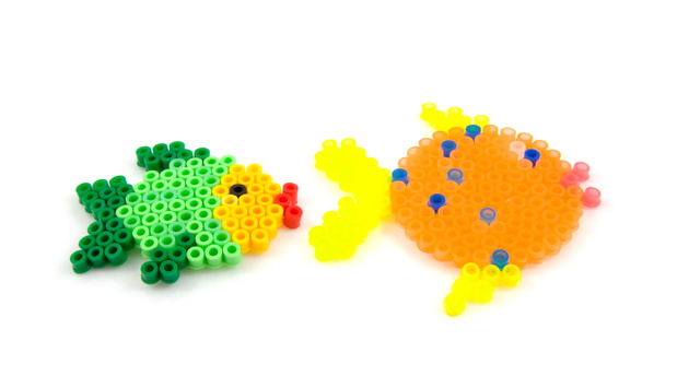 Bead arts in the shap of fish over white background