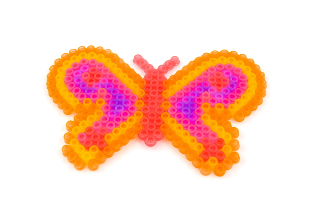 Beads art in the shape of butterfly over white backround