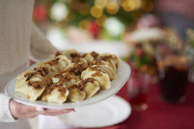 Woman serving plate full of dumplings