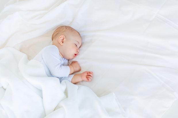 Close-up portrait of adorable baby boy sleeping in bed, 1 year old baby concept
