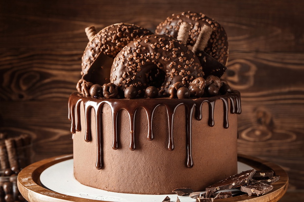 Sweet chocolate cake on wooden background