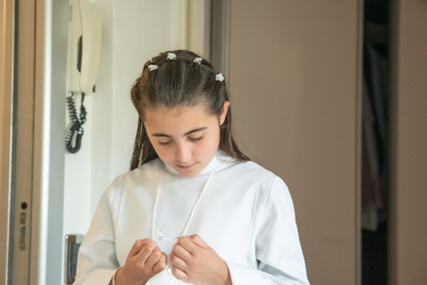 Happy young girl dressed as first communion.
