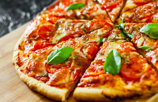 sliced Pizza with Mozzarella cheese, Tomatoes, pepper, Spices an