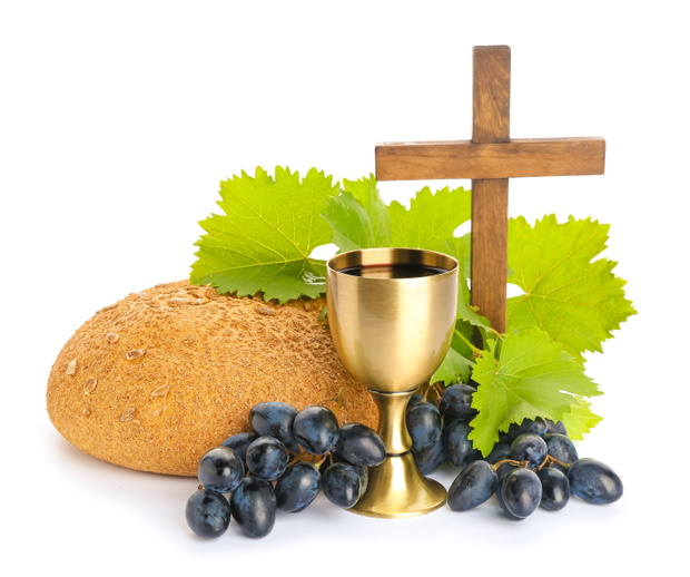 Chalice of wine, cross and bread on white background