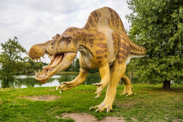 ROGOWO, POLAND - Sep 26, 2021: View of spinosaurus sculpture with open jaws in Zaurolandia dinosaur park, Rogowo, Poland