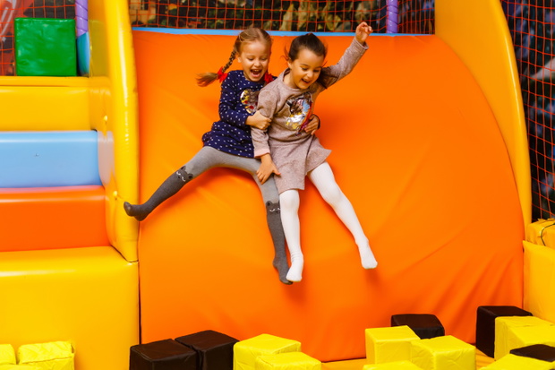 Two sisters bouncing in the trampoline park