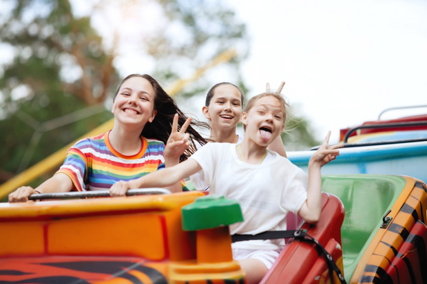 Three teenage girls are having fun.