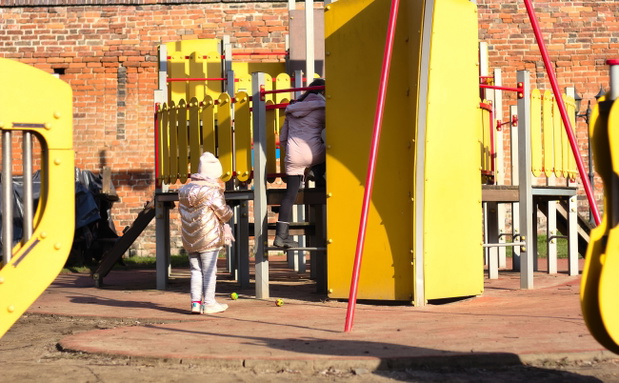 Children playing in the playground on a sunny cold day in early
