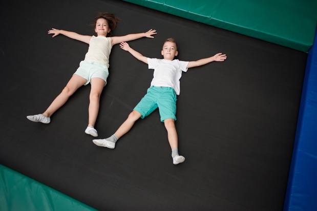 Little children are jumping on the trampoline