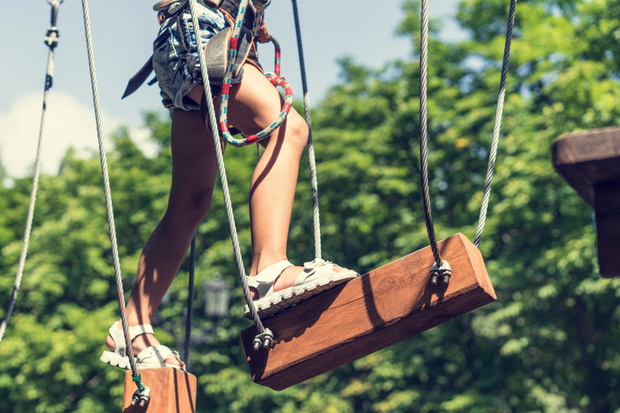 Child climbing on high rope park. adventure climbing high wire park