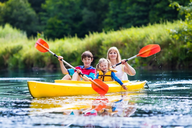 Family enjoying kayak ride on a river