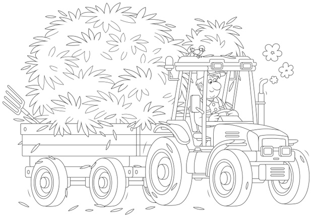 Smiling farmer driving his wheeled tractor with a trailer of hay