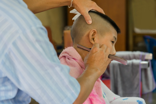 Young Asia boy getting his head shaved at barber